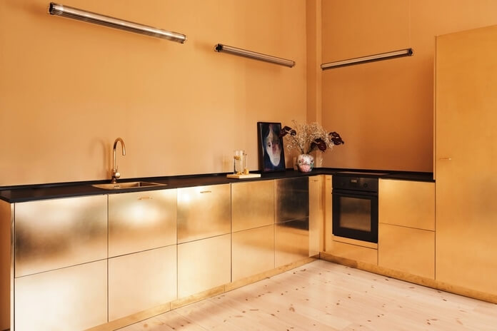 Orange walls and gold kitchen